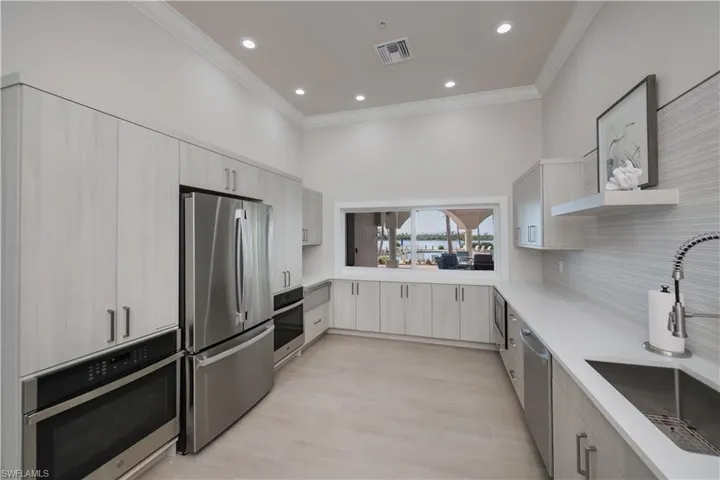 Kitchen featuring open shelves, stainless steel appliances, recessed lighting, decorative backsplash, and crown molding