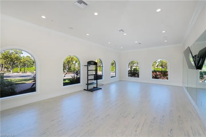 Unfurnished living room with crown molding, light wood-style flooring, and recessed lighting