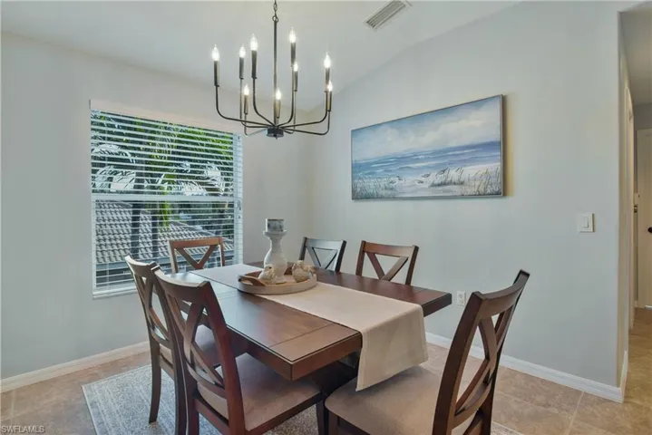 Dining area with vaulted ceiling and suspended lighting
