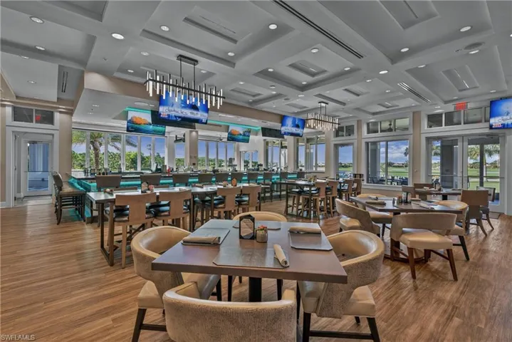 Dining space featuring coffered ceiling, recessed lighting, wood finished floors, and healthy amount of natural light