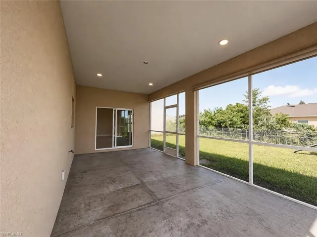 Screened patio with a concrete floor, recessed lighting, and sliding glass doors