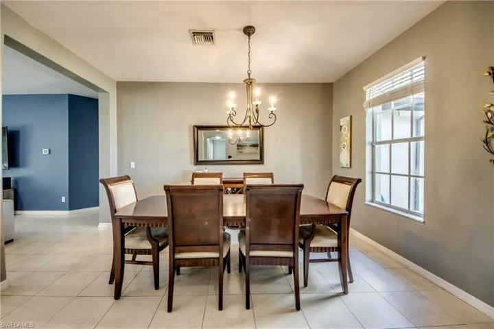 Dining room featuring suspended lighting and baseboards