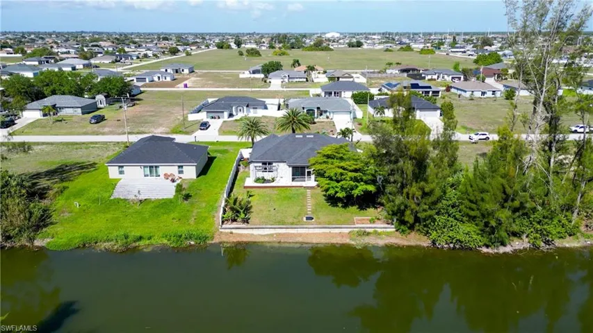 Aerial perspective of suburban area with a nearby body of water
