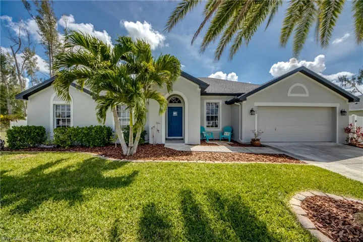 Ranch-style home with stucco siding, concrete driveway, a garage, and a front lawn