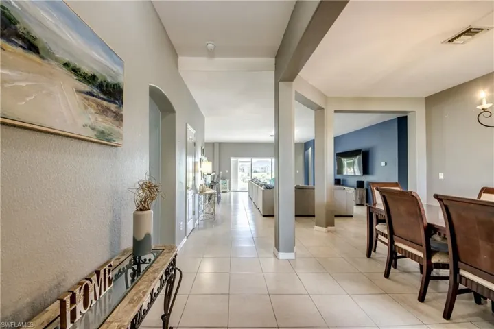 Corridor featuring light tile patterned floors and a textured wall