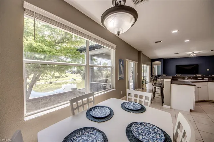 Dining space with recessed lighting and light tile patterned floors