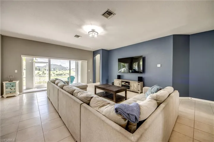 Living room with baseboards and light tile patterned flooring