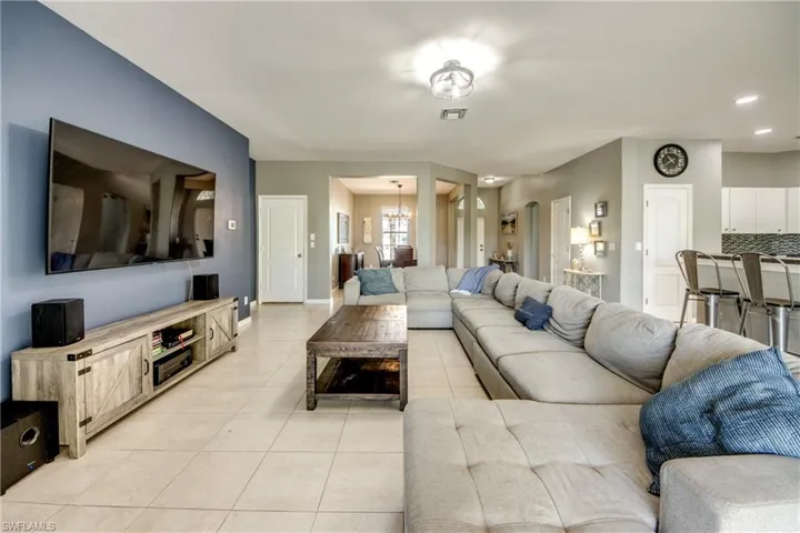 Living room with light tile patterned floors and a chandelier