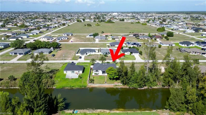 Aerial overview of property's location featuring nearby suburban area and a nearby body of water