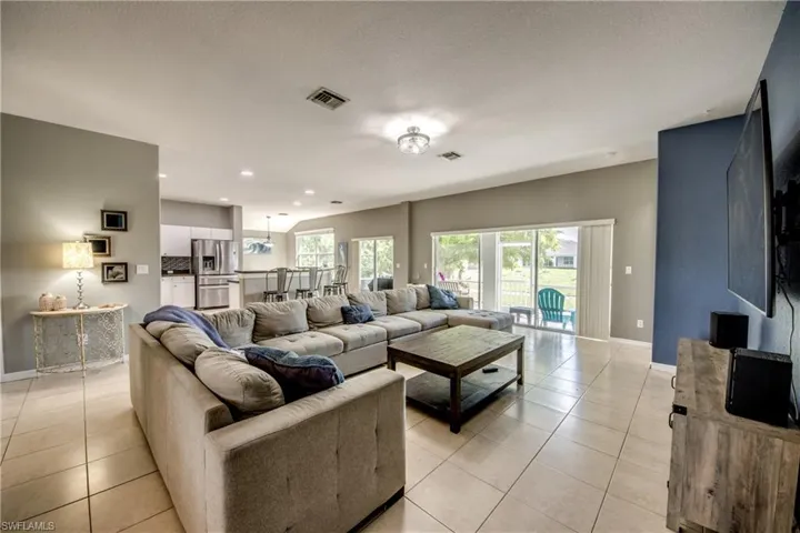 Living room featuring light tile patterned floors and recessed lighting