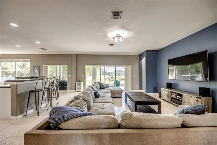 Living area featuring light tile patterned floors and healthy amount of natural light
