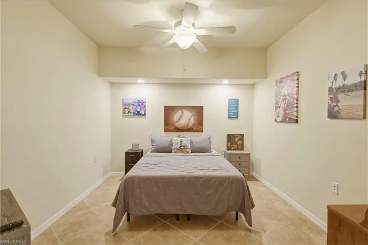Bedroom featuring a ceiling fan and baseboards