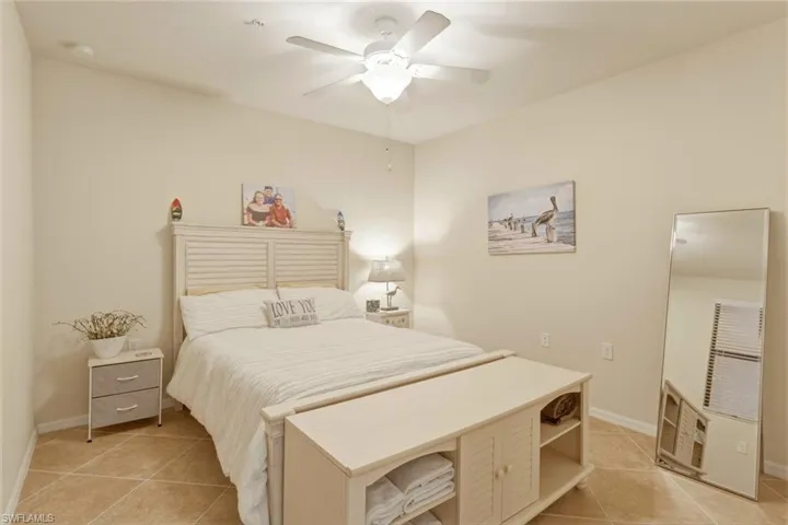 Bedroom featuring light tile patterned flooring and ceiling fan