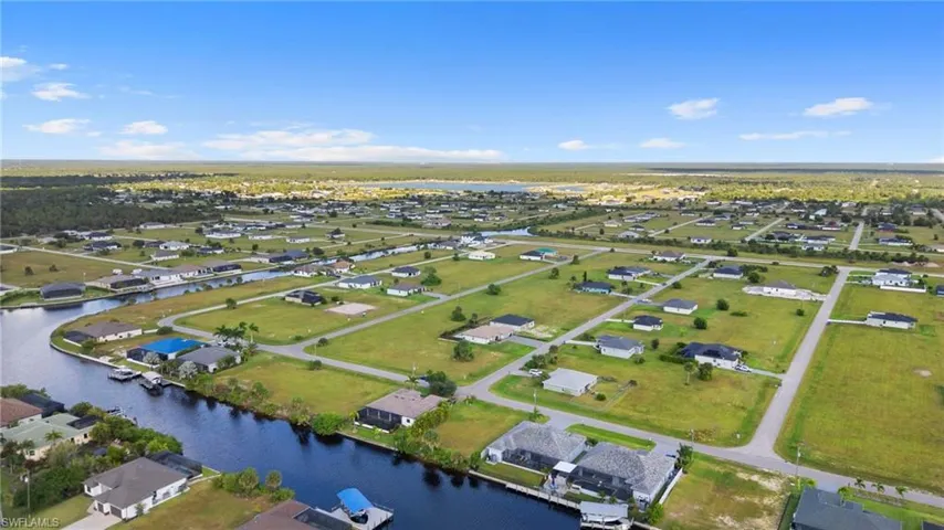 Aerial view of property's location with nearby suburban area and a large body of water