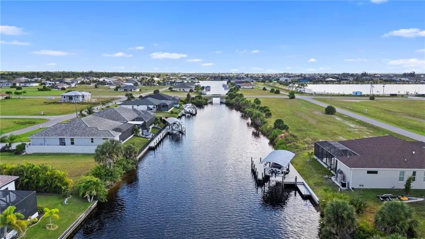 Aerial view of residential area featuring a nearby body of water