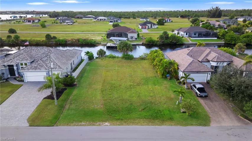 Aerial perspective of suburban area featuring a large body of water