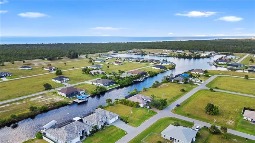 View of property location featuring a nearby body of water and nearby suburban area