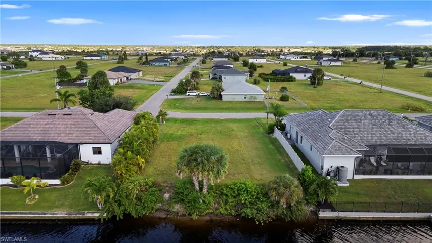 Aerial perspective of suburban area with a nearby body of water