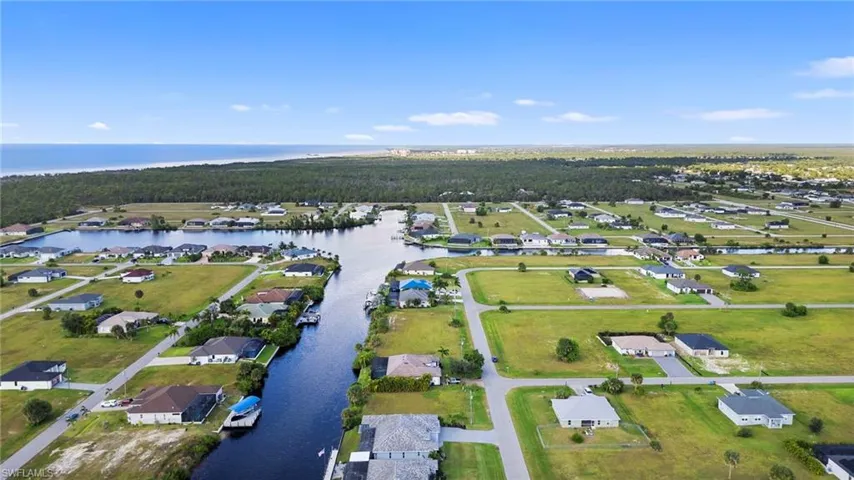View of property location featuring a large body of water and nearby suburban area
