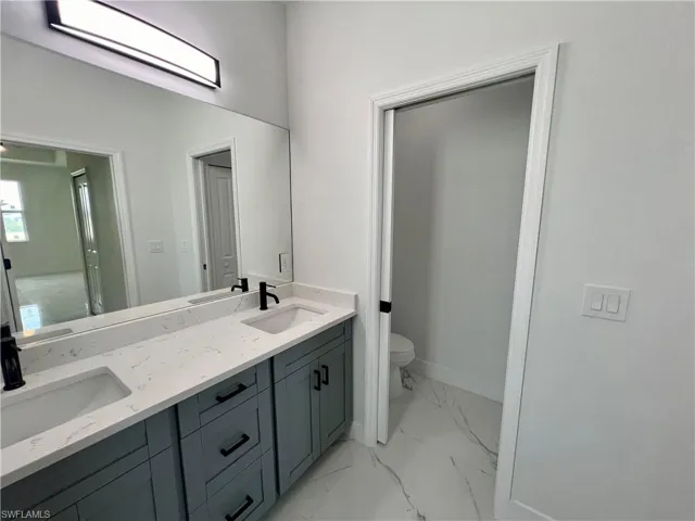 Bathroom featuring vanity and toilet