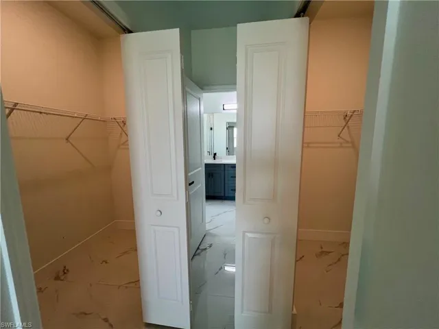 View of two walk in closets in primary bedroom