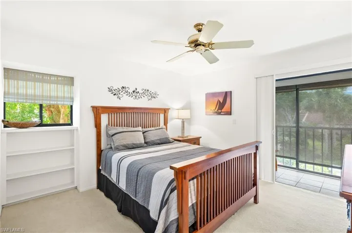 Bedroom with carpet floors, access to exterior, and ceiling fan