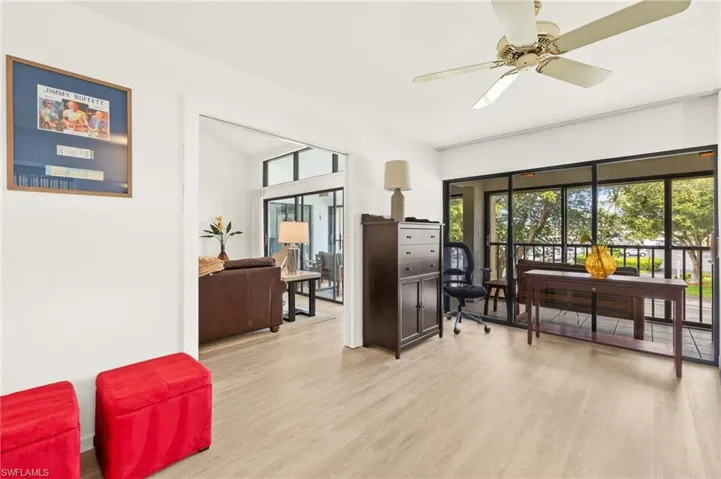 Bedroom/den with wood finished floors and a ceiling fan and closet