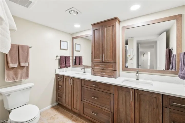 Bathroom with visible vents, a sink, toilet, and tile patterned flooring
