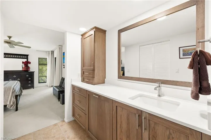 Ensuite bathroom featuring tile patterned flooring, vanity, ensuite bathroom, and ceiling fan