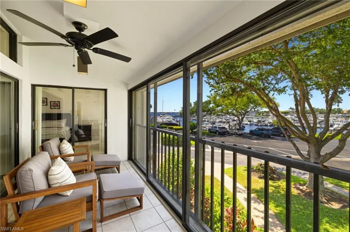 Sunroom featuring tile patterned floors, ceiling fan, and vaulted ceiling