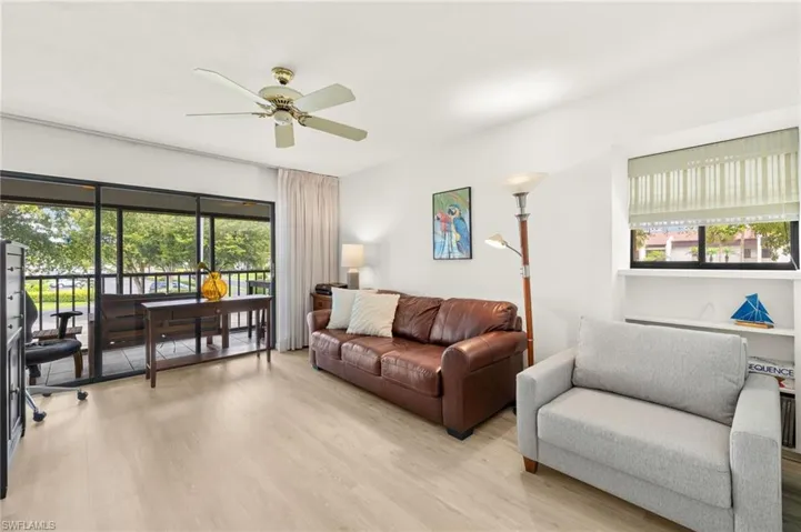 Bedroom/den with light wood-style floors and a ceiling fan and closet