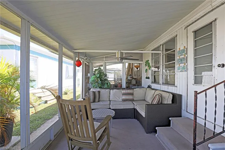 Sunroom featuring lofted ceiling, an outdoor hangout area, and ceiling fan