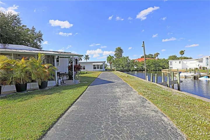 Dock with a lawn and a water view