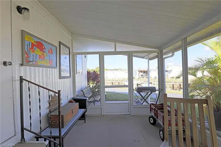 Sunroom featuring vaulted ceiling and a water view