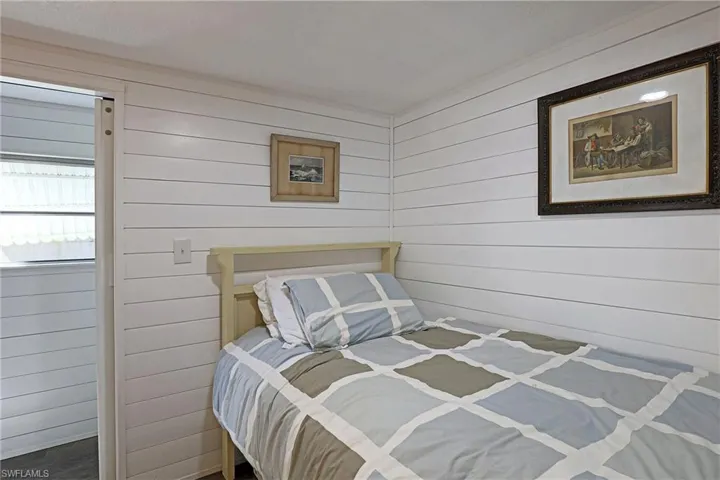 Bedroom featuring wooden walls