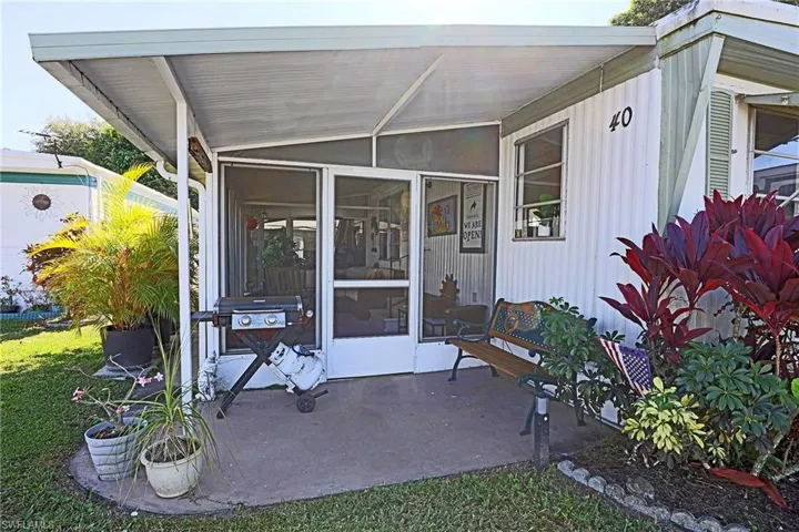 View of exterior entry with a sunroom