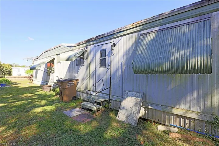 View of side of property with a lawn