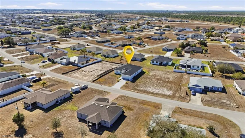 Aerial view of property's location with nearby suburban area