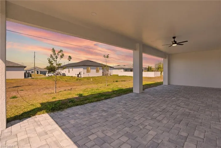 View of patio / terrace featuring a ceiling fan and a residential view