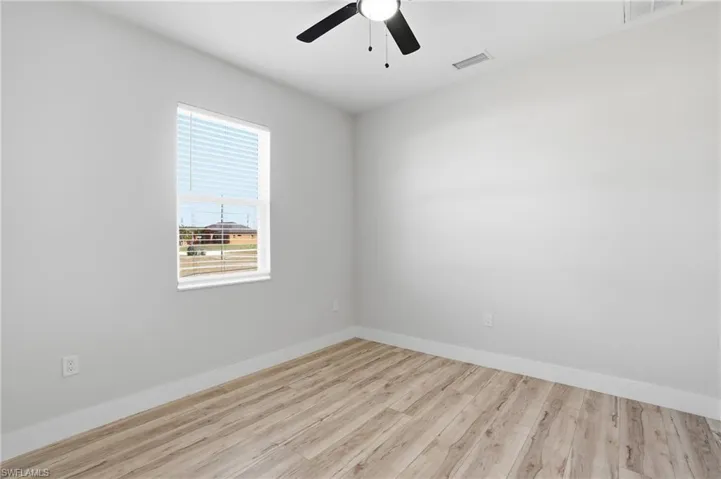 Spare room featuring light wood-style floors and a ceiling fan