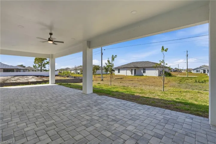 View of patio with a residential view and ceiling fan