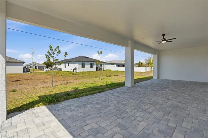 View of patio / terrace with ceiling fan and a residential view