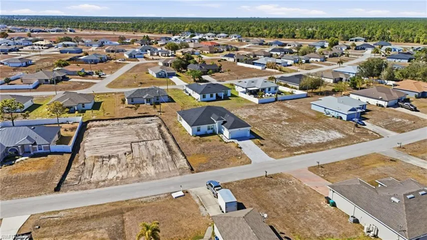 Aerial view of property's location featuring nearby suburban area