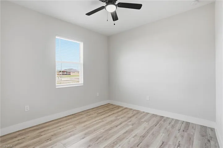 Spare room with light wood-type flooring and a ceiling fan