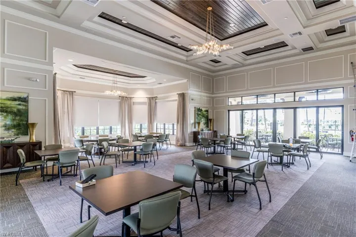 Building lobby featuring crown molding and high coffered ceiling