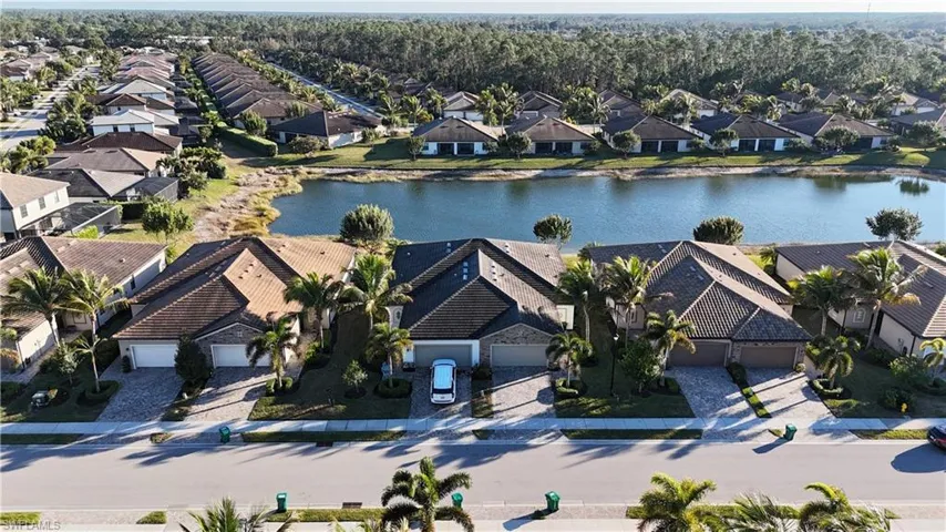 Aerial perspective of suburban area featuring a large body of water