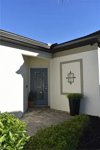 Doorway to property with stucco siding