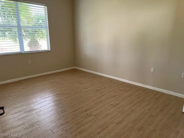 View of Primary bedroom with out furniture looking toward golf course view window.
