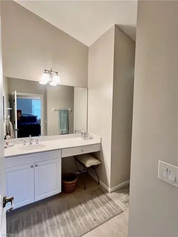 Guest bath with white cultured marble counter and sink.