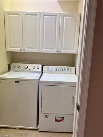 Laundry room with white cabinets